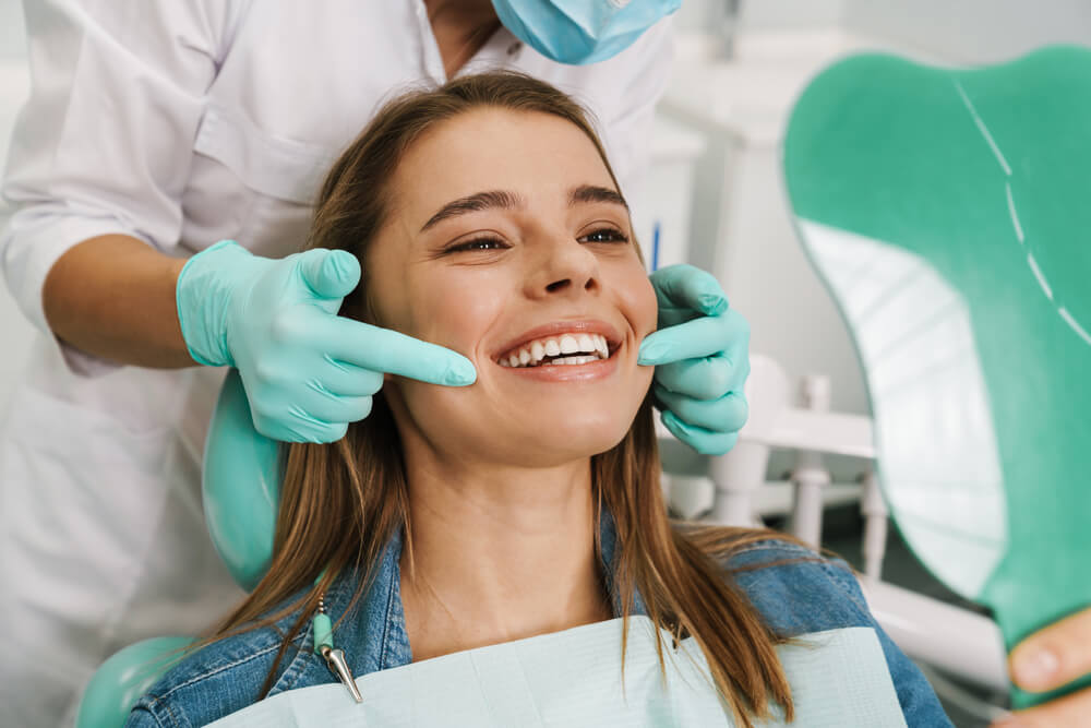 close up of a dentist attending to smiling patient