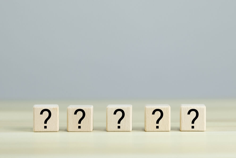 several question marks on table surface
